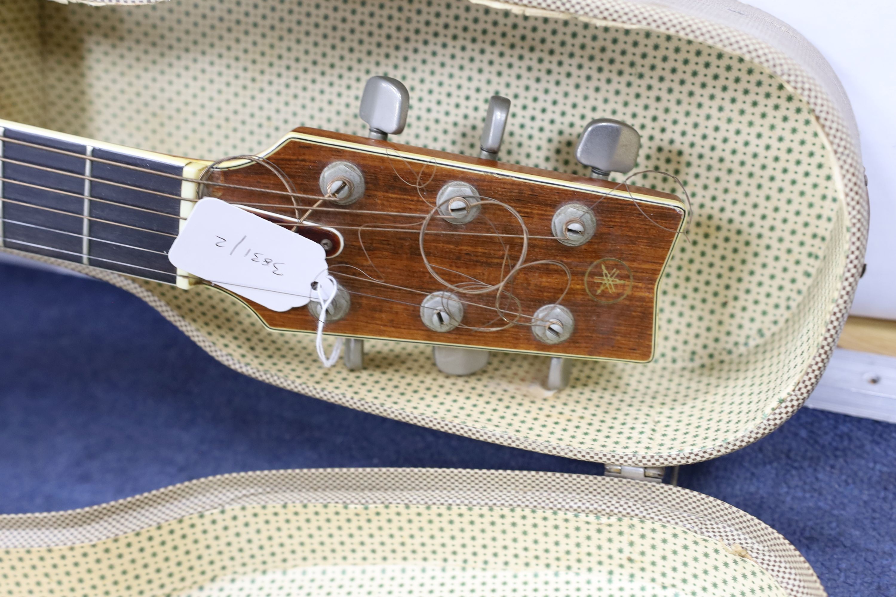 A Yamaha FG-700 acoustic guitar in hard case